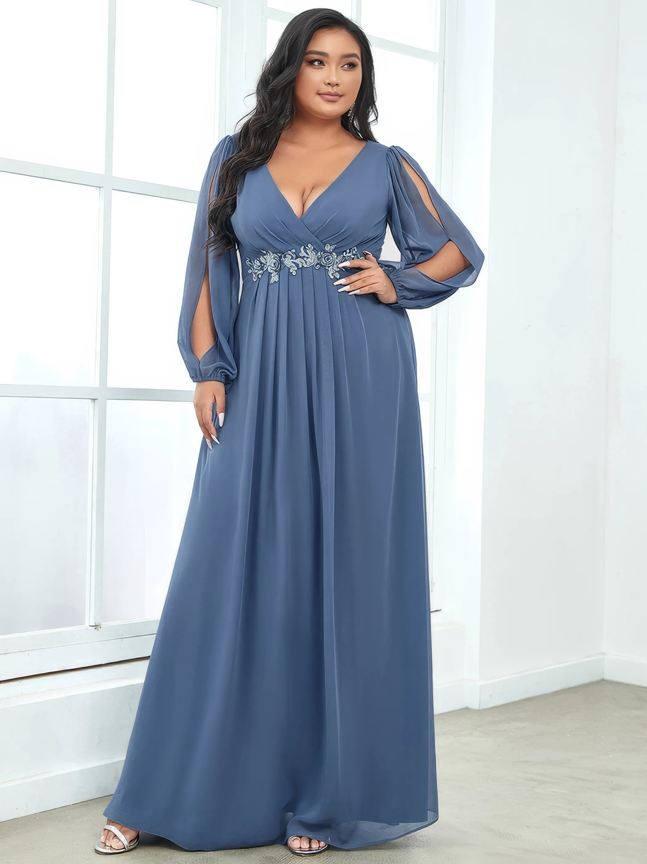 Frau in einem raubblauen Chiffon-Abendkleid mit V-Ausschnitt und langen Ärmeln